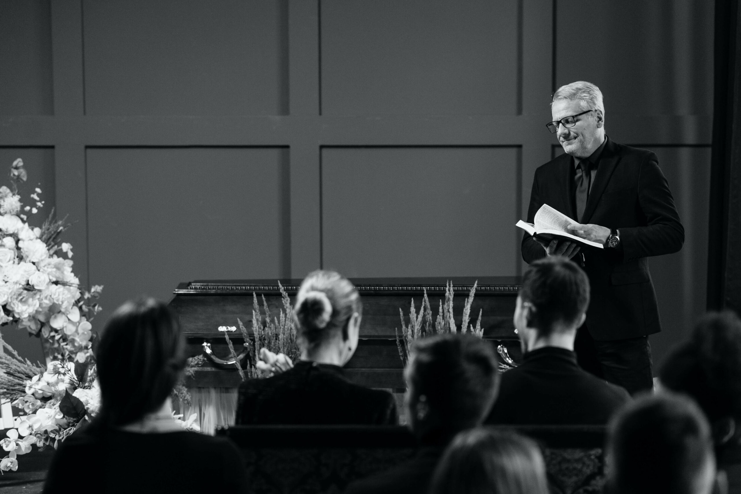 people at funeral in black and white